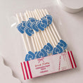 Load image into Gallery viewer, Baby feet blue pink paper straw toppers pack of 12 in clear packaging, perfect for baby showers and gender reveal parties.