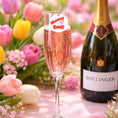 Load image into Gallery viewer, Edible drink toppers for cocktails on a sparkling wine glass surrounded by colorful flowers.