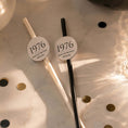 Load image into Gallery viewer, Personalised birthday year straw toppers with 1976 design on black and white straws, perfect for celebrations.
