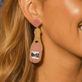 Load image into Gallery viewer, Rose Wine Bottle beaded earrings My Doris worn by a model, showcasing colorful pink and gold beads.
