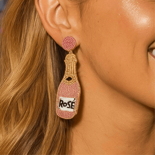 Rose Wine Bottle beaded earrings My Doris worn by a model, showcasing colorful pink and gold beads.