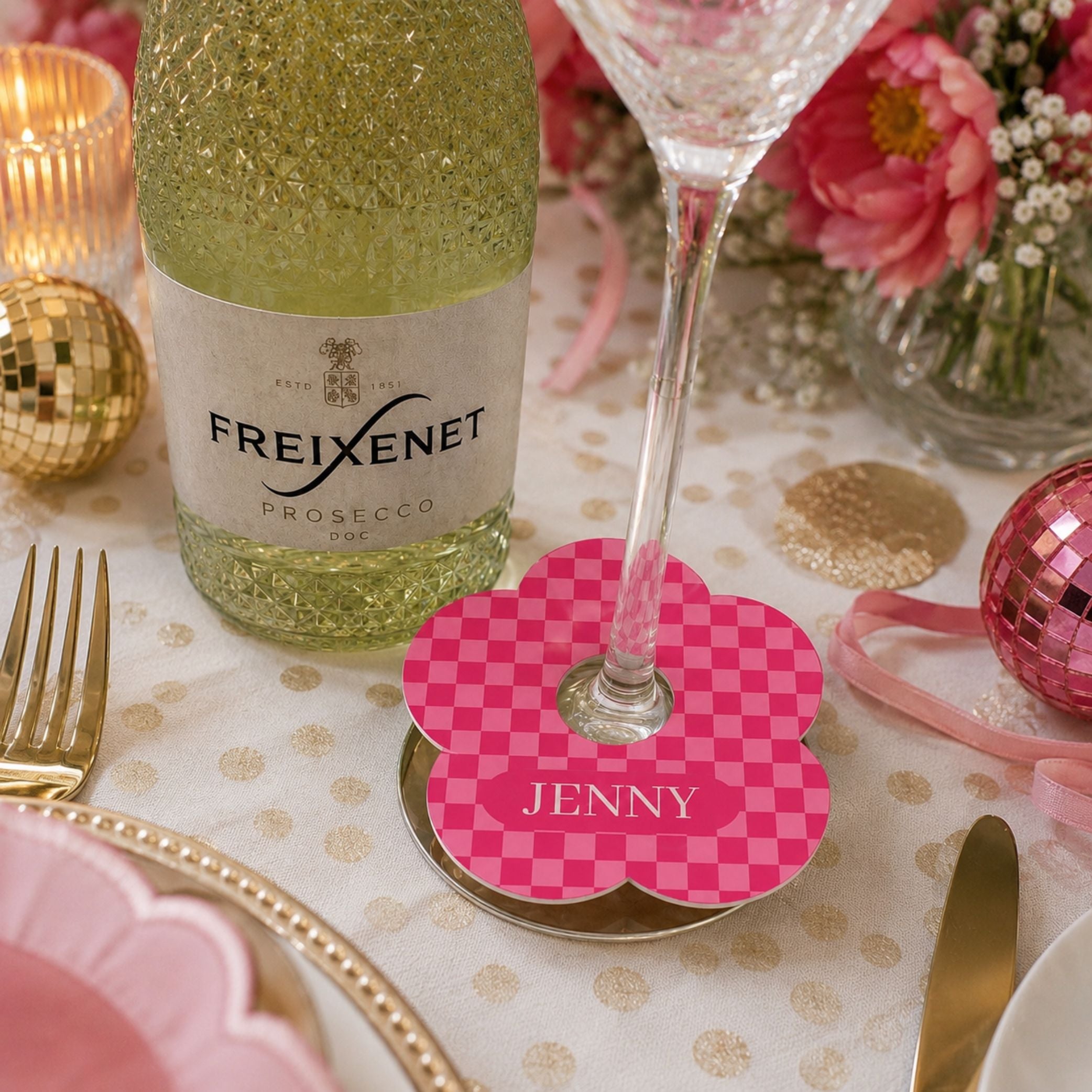 Vibrant Check personalised name drink markers on table with prosecco bottle and festive decor.