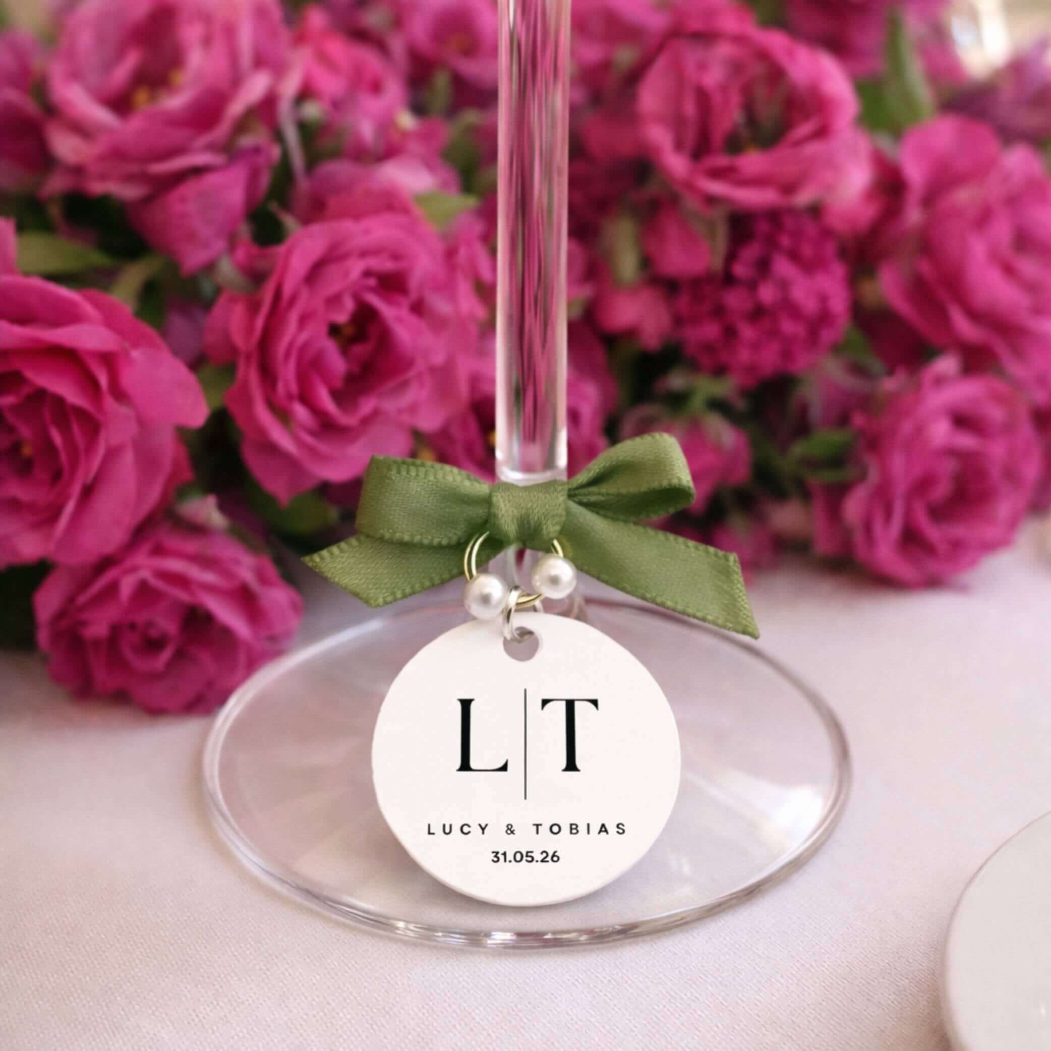 Personalised wine charms for weddings featuring monogram initials and pearl embellishments.