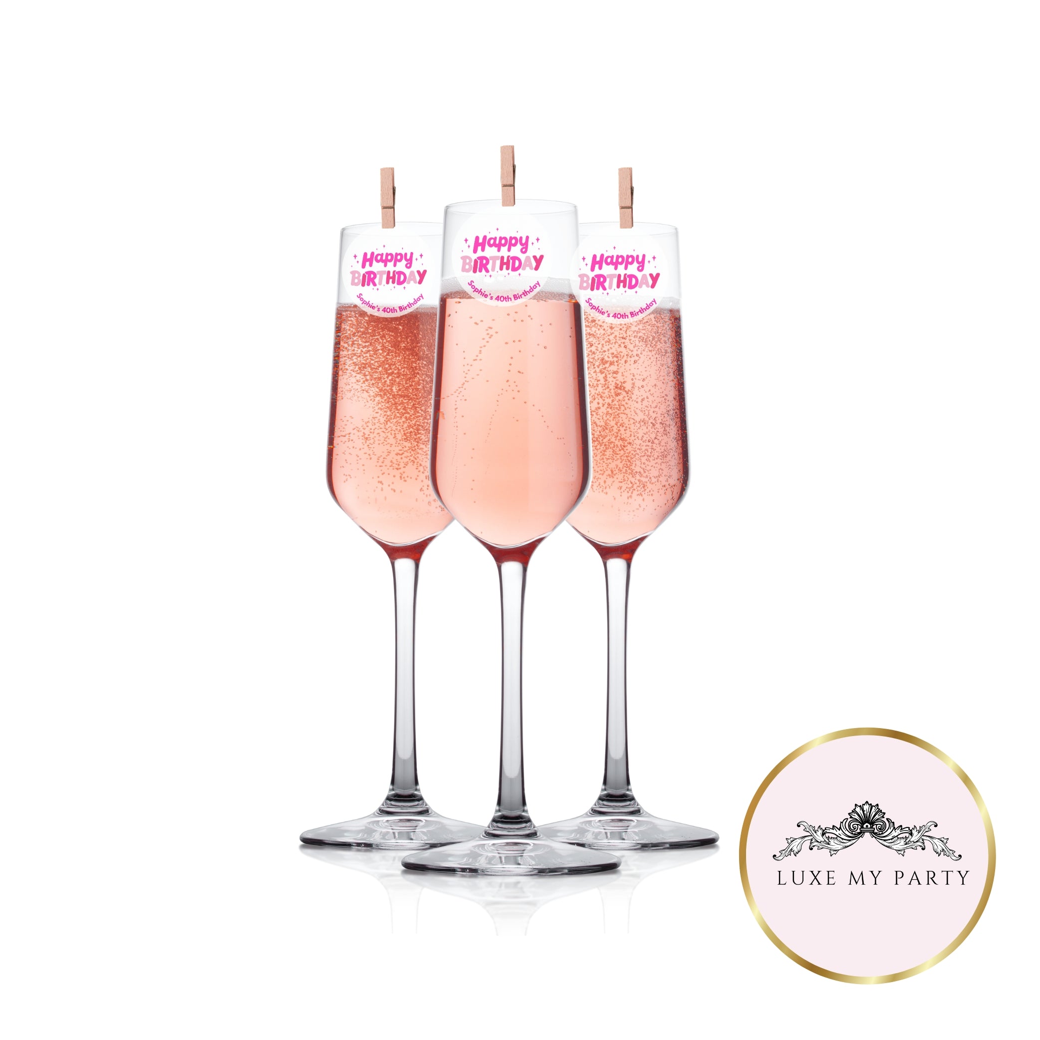 Champagne glasses with happy birthday edible toppers with wooden pegs