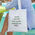 Load image into Gallery viewer, Funny wine tote bag with humorous text about choosing wine over milk, perfect for wine lovers.
