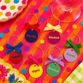 Load image into Gallery viewer, Tipsy Quotes Wine Glass Charm Set Of 6 featuring colorful charms with fun phrases on a vibrant table setting.
