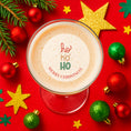 Load image into Gallery viewer, Ho Ho Ho Christmas edible drink toppers on a festive cocktail surrounded by Christmas decorations.

