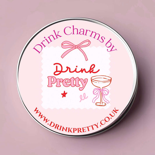 Mr and Mrs wine charms set in a stylish reusable tin with a pink and white design.