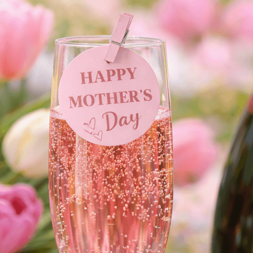 Cheers with a sparkling drink featuring a tag that says "HAPPY MOTHER'S DAY" for Mother's Day celebrations.
