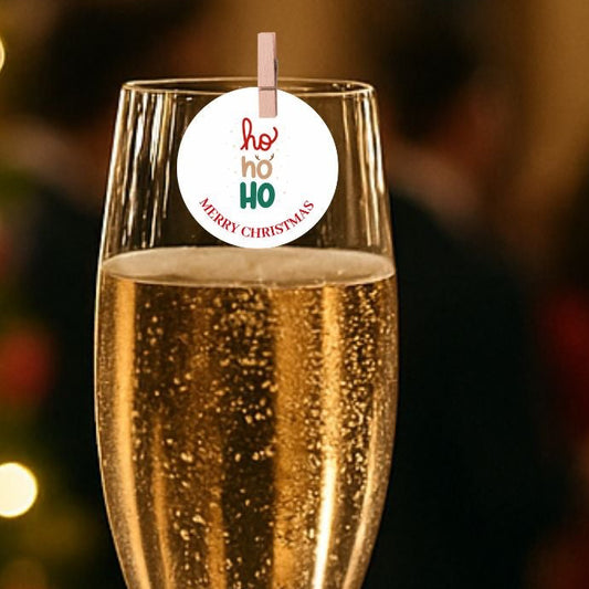 Ho Ho Ho Christmas edible drink toppers on a champagne glass for festive celebrations.