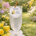 Load image into Gallery viewer, Mum To Bee drink topper on glass at a baby shower celebration in a garden with flowers.

