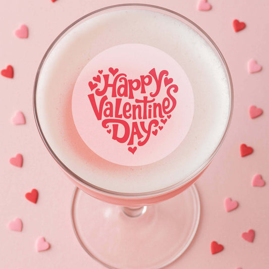 Valentines Day edible drink toppers on a cocktail with heart decorations for a festive celebration.