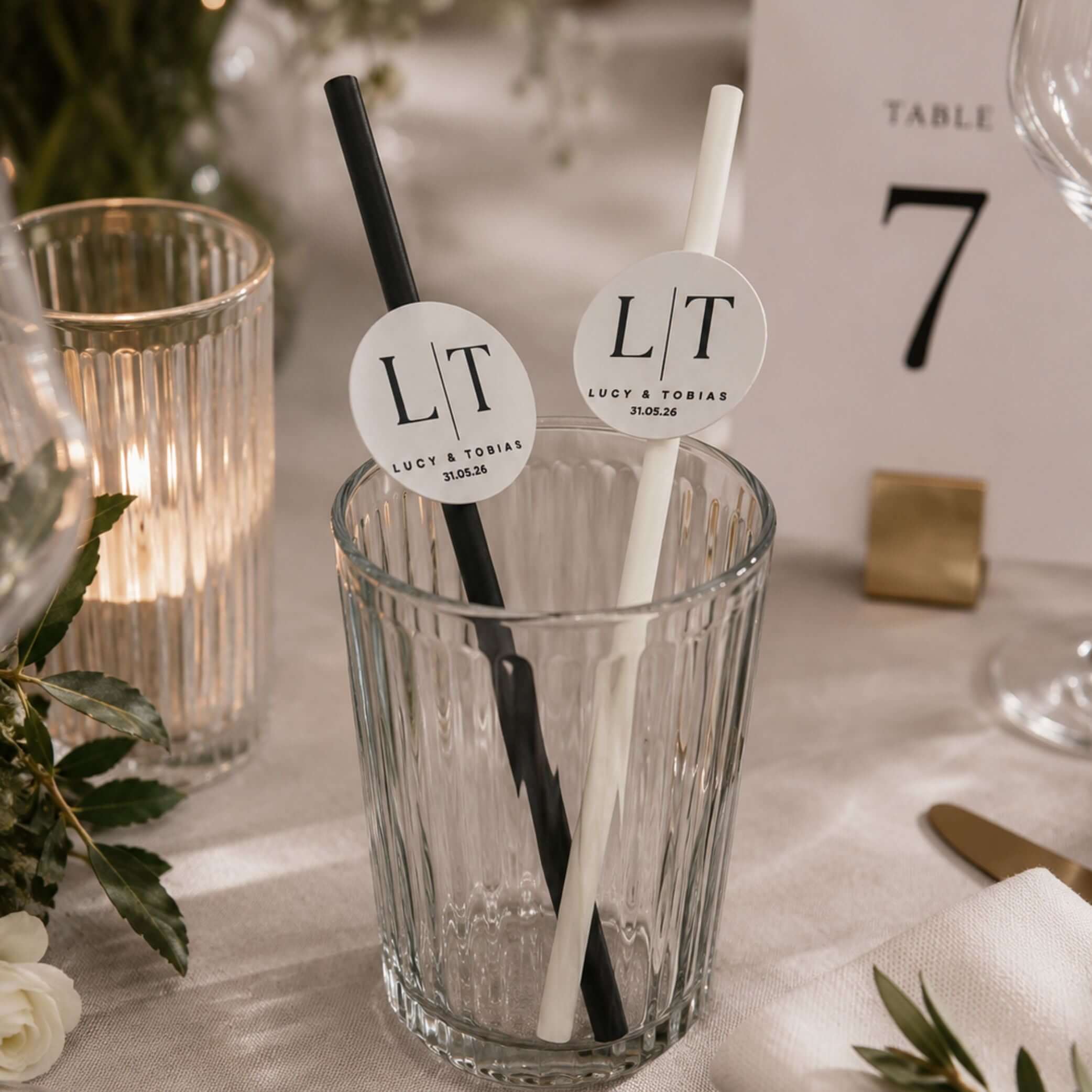 Occasion paper straws personalised initials toppers in a glass with black and white straws for weddings and events.