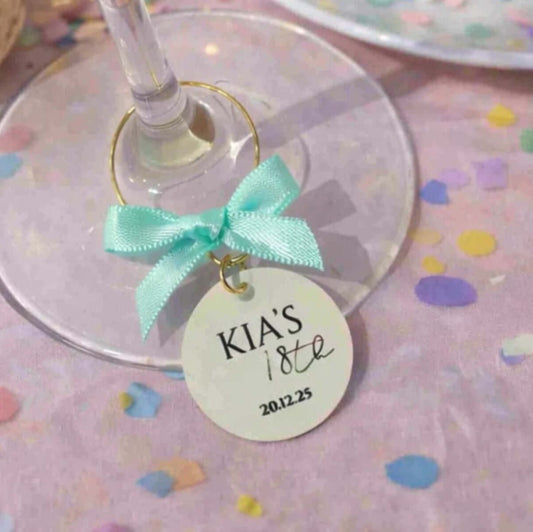 Personalised Birthday Party Wine Charms featuring a charm with KIA'S 18th birthday on a wine glass.