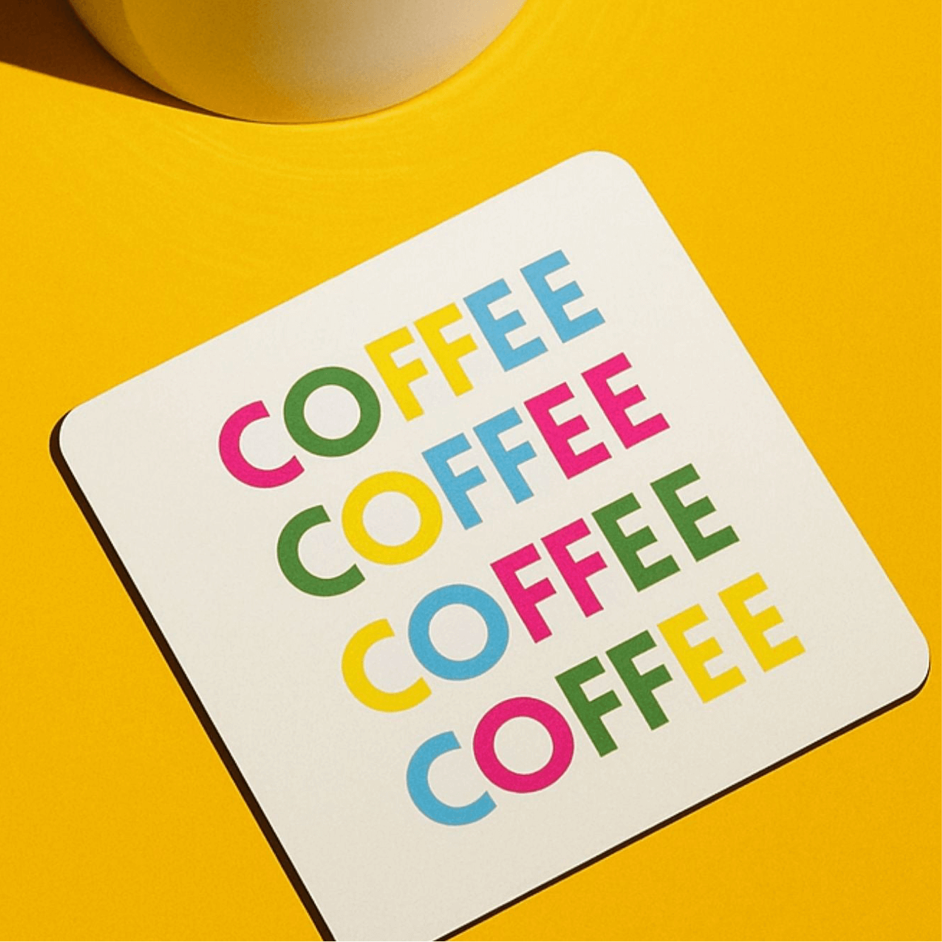 Coffee drink coaster featuring colorful 'COFFEE' text on a bright yellow background.