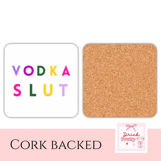 Vodka Slut Drink Coaster with colorful text on white surface and cork backing, perfect for adding humor to drinks.