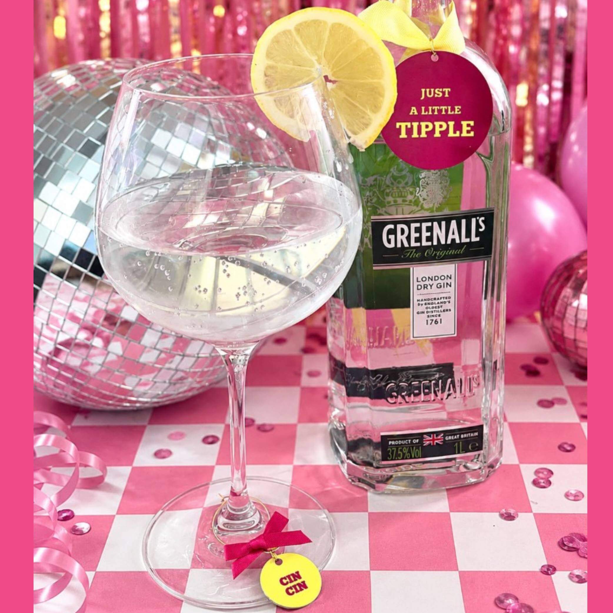 Just A little Tipple Bottle Charm Gift Tag displayed with a glass of gin and lemon slice on a festive table.