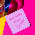 Load image into Gallery viewer, Save water drink champagne drink coaster on a colorful background next to a glass of drink.
