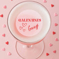 Load image into Gallery viewer, Edible drink toppers for cocktails featuring 'Galentines Gang' on a pink cocktail surrounded by heart-shaped sprinkles.
