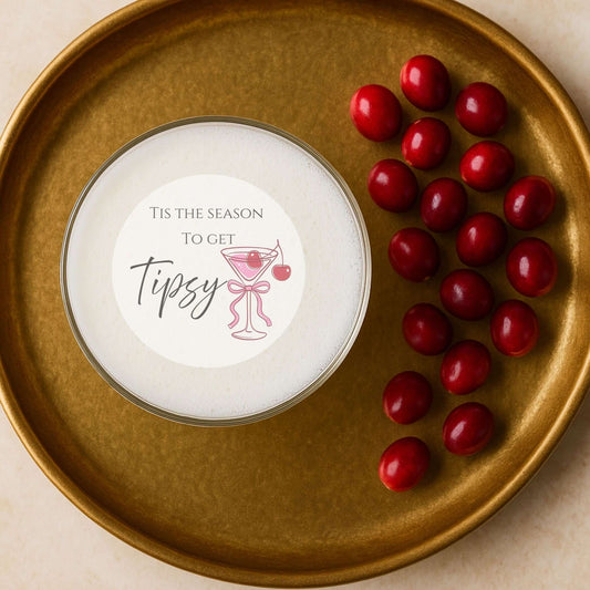 Tis The Season To Get Tipsy edible drink topper on a gold plate with cranberries for stylish holiday cocktails.
